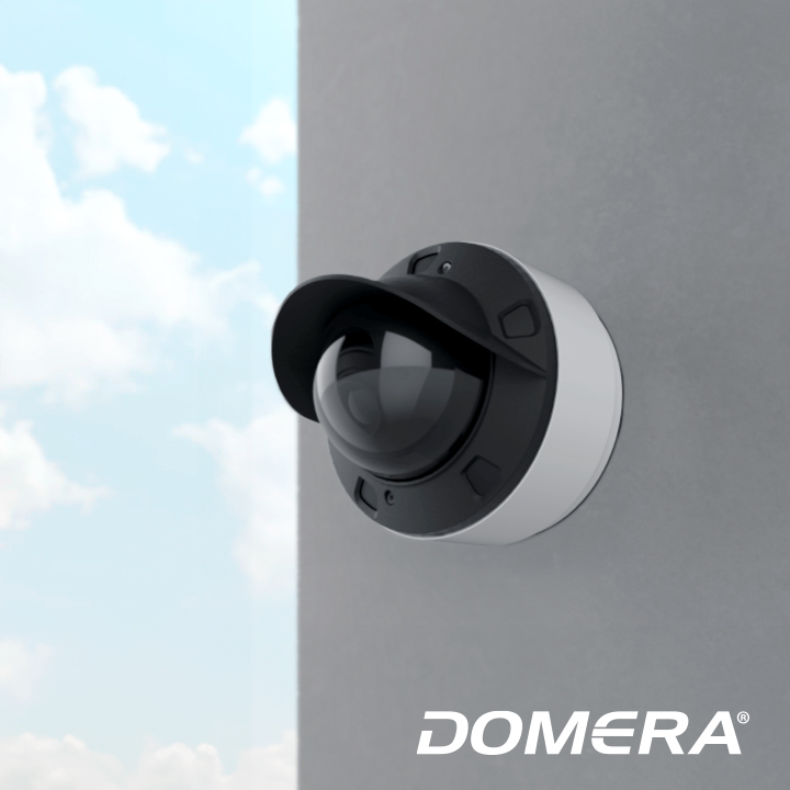 Domera security camera mounted on a grey wall