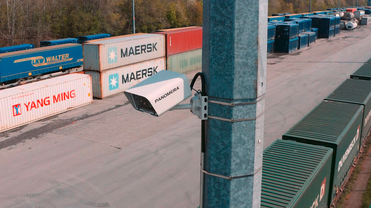 Panomera® camera hanging on a mast, logistics containers in the background.